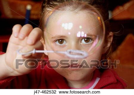 3 year old girl holding a bubble right infront of her nose View Large Photo Image Stock Image - 3 year old girl holding a bubble right infront of her nose. Fotosearch