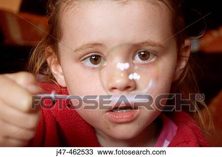 3 year old girl holding a bubble right infront of her nose View Large Photo Image Stock Image - 3 year old girl holding a bubble right infront of her nose. Fotosearch