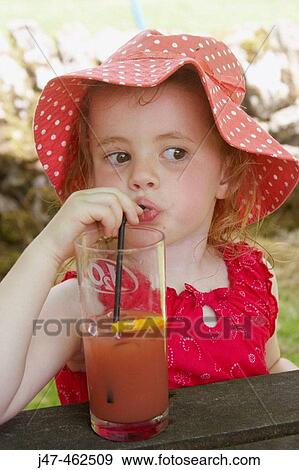 3 year old girl in a big floppy red hat, drinking through a straw View Large Photo Image Stock Photo - 3 year old girl in a big floppy red hat, drinking through a straw. Fotosearch