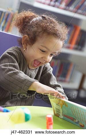 3 year old girl in a library looking at books laughing View Large Photo Image Stock Image - 3 year old girl in a library looking at books laughing. Fotosearch