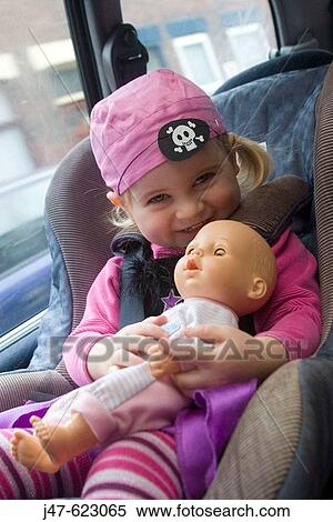 3 year old girl laughing into camera, wearing a pirate outfit, sitting in the carseat, holding her doll View Large Photo Image Stock Photography - 3 year old girl laughing into camera, wearing a pirate outfit, sitting in the carseat, holding her doll. Fotosearch