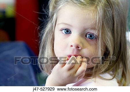3 year old girl, looking into camera, at nursery, serious, hand in her mouth View Large Photo Image Stock Photo - 3 year old girl, looking into camera, at nursery, serious, hand in her mouth. Fotosearch