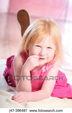 3 year old girl lying on her tummy, smiling into camera View Large Photo Image Stock Photo - 3 year old girl lying on her tummy, smiling into camera. Fotosearch