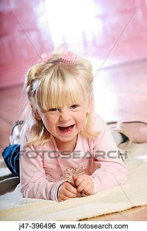 3 year old girl lying on her tummy, laughing into camera View Large Photo Image Stock Photograph - 3 year old girl lying on her tummy, laughing into camera. Fotosearch