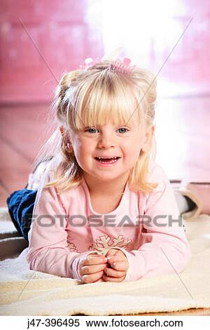 3 year old girl lying on her tummy, smiling into camera View Large Photo Image Stock Photography - 3 year old girl lying on her tummy, smiling into camera. Fotosearch
