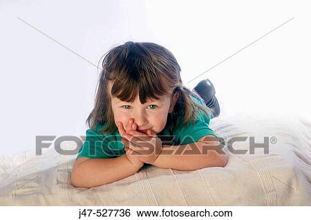 3 year old girl lying on tummy, smiling into camera View Large Photo Image Stock Photograph - 3 year old girl lying on tummy, smiling into camera. Fotosearch