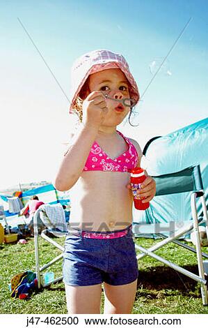 3 year old girl outside in the sunshine, on a camping trip, blowing bubbles View Large Photo Image Stock Image - 3 year old girl outside in the sunshine, on a camping trip, blowing bubbles. Fotosearch