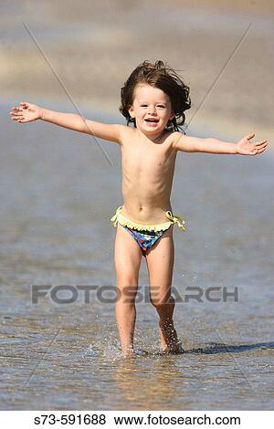 3 year old girl running on the beach View Large Photo Image Stock Photo - 3 year old girl running on the beach. Fotosearch