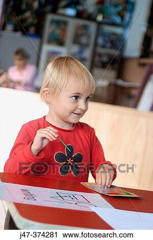 3 year old girl sitting at a desk, at nursrey school View Large Photo Image Stock Image - 3 year old girl sitting at a desk, at nursrey school. Fotosearch