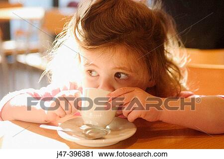 3 year old girl sitting in a cake drinking from tiny china cup View Large Photo Image Stock Image - 3 year old girl sitting in a cake drinking from tiny china cup. Fotosearch