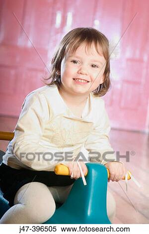 3 year old girl sitting on a seesaw, smiling into camera View Large Photo Image Stock Photography - 3 year old girl sitting on a seesaw, smiling into camera. Fotosearch