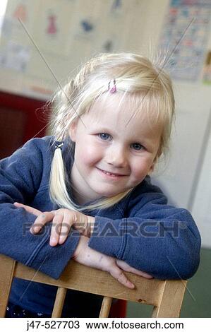 3 year old girl smiling into camera at nursery View Large Photo Image Stock Image - 3 year old girl smiling into camera at nursery. Fotosearch