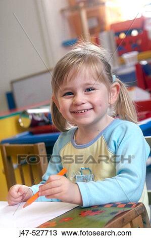 3 year old girl smiling into camera at nursery View Large Photo Image Stock Image - 3 year old girl smiling into camera at nursery. Fotosearch