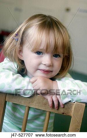 Stock Photo - 3 year old girl smiling into camera at nursery. Fotosearch