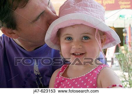 3 year old girl smiling into camera with her father kissing her View Large Photo Image Stock Image - 3 year old girl smiling into camera with her father kissing her. Fotosearch