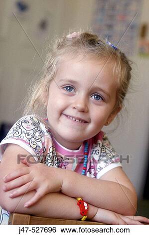 3 year old girl smiling off camera at nursery View Large Photo Image Stock Photograph - 3 year old girl smiling off camera at nursery. Fotosearch