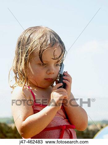 3 year old girl standing outside in a swimming costume on a mobile phone View Large Photo Image Stock Image - 3 year old girl standing outside in a swimming costume on a mobile phone. Fotosearch