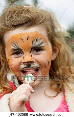 3 year old girl with her face painted, looking at the camera, smiling, eating a lolly View Large Photo Image Stock Photo - 3 year old girl with her face painted, looking at the camera, smiling, eating a lolly. Fotosearch