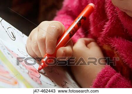 Stock Image - 3 year old girls hands drawing. Fotosearch