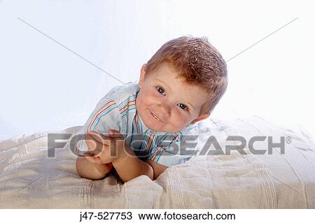 3 year old, red haired boy smiling into camera, lying on his stomach View Large Photo Image Stock Image - 3 year old, red haired boy smiling into camera, lying on his stomach. Fotosearch