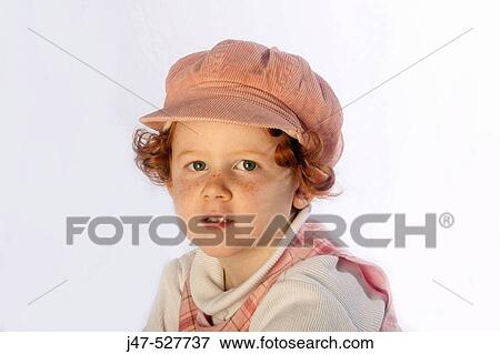 3 year old, red haired girl wearing a hat, gazing into the camera View Large Photo Image Stock Photo - 3 year old, red haired girl wearing a hat, gazing into the camera. Fotosearch