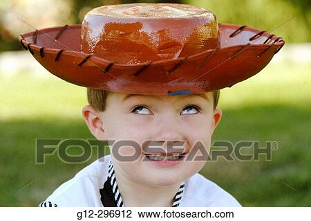 3 years old boy wearing plastic cowboy hat looking upward. Boise, Idaho. USA View Large Photo Image Stock Image - 3 years old boy wearing plastic cowboy hat looking upward. Boise, Idaho. USA. Fotosearch