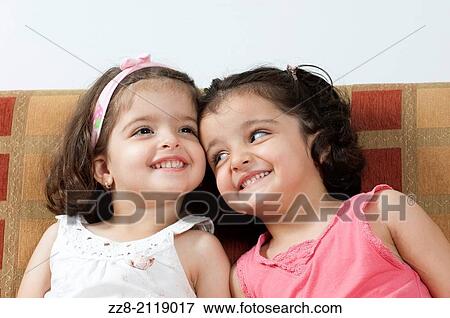 3 years old twin sisters smiling. View Large Photo Image Stock Photo - 3 years old twin sisters smiling.. Fotosearch
