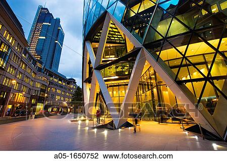 Stock Image - 30 St Mary Axe or Swiss Re Building nicknamed The Gherkin by architect Norman Foster London England United Kingdom, UK, Europe.. Fotosearch