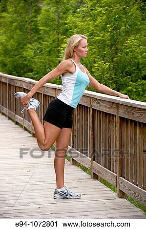 30 year old blonde woman in work out clothes stretching View Large Photo Image Stock Image - 30 year old blonde woman in work out clothes stretching. Fotosearch