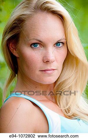 Stock Image - 30 year old blonde woman in work out clothes looking at camera. Fotosearch