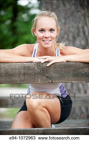 Stock Image - 30 year old blonde woman in work out clothes smiling at camera. Fotosearch