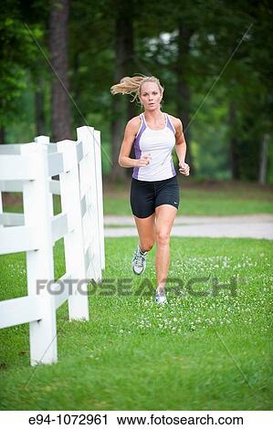 30 year old blonde woman jogging in work out clothes View Large Photo Image Stock Image - 30 year old blonde woman jogging in work out clothes. Fotosearch