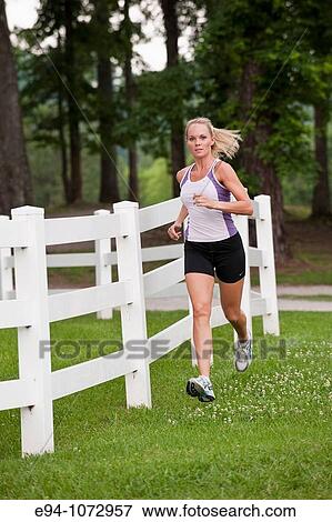 30 year old blonde woman jogging in work out clothes View Large Photo Image Stock Photo - 30 year old blonde woman jogging in work out clothes. Fotosearch