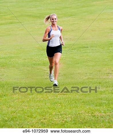 30 year old blonde woman jogging in work out clothes View Large Photo Image Stock Photo - 30 year old blonde woman jogging in work out clothes. Fotosearch