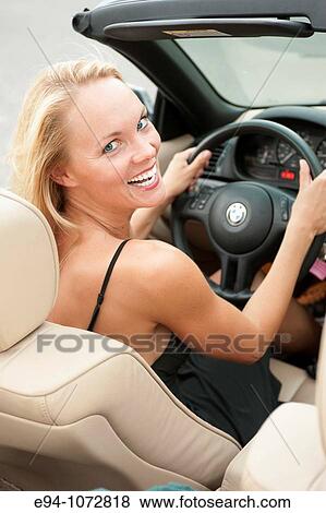 30 year old blonde woman looking over shoulder while driving View Large Photo Image Stock Photo - 30 year old blonde woman looking over shoulder while driving. Fotosearch