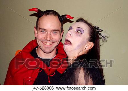 30 year old couple dressed up in Halloween fancy dress, shes pulling a scary face at him View Large Photo Image Stock Photograph - 30 year old couple dressed up in Halloween fancy dress, shes pulling a scary face at him. Fotosearch