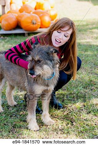 30 Year old redheaded woman with a mixed-breed dog outdoors View Large Photo Image Stock Image - 30 Year old redheaded woman with a mixed-breed dog outdoors. Fotosearch