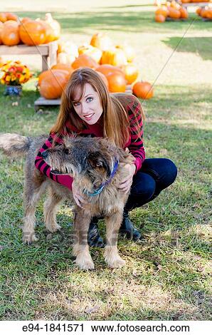 30 Year old redheaded woman with a mixed-breed dog outdoors View Large Photo Image Stock Image - 30 Year old redheaded woman with a mixed-breed dog outdoors. Fotosearch