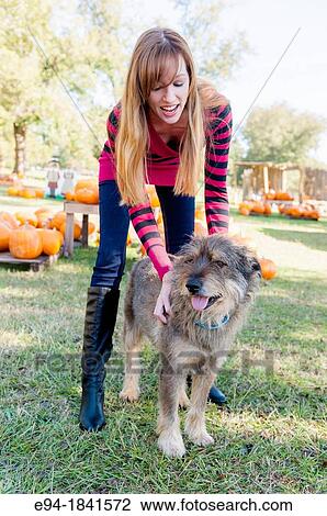 30 Year old redheaded woman with a mixed-breed dog outdoors View Large Photo Image Stock Image - 30 Year old redheaded woman with a mixed-breed dog outdoors. Fotosearch