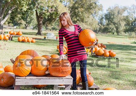 30 Year old redheaded woman with pumpkins in autumn View Large Photo Image Picture - 30 Year old redheaded woman with pumpkins in autumn. Fotosearch