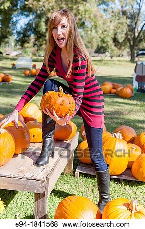 30 Year old redheaded woman with pumpkins in autumn View Large Photo Image Stock Photo - 30 Year old redheaded woman with pumpkins in autumn. Fotosearch
