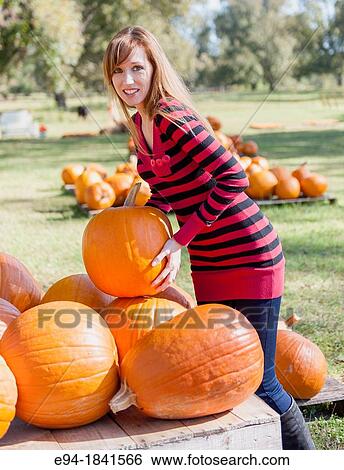 30 Year old redheaded woman with pumpkins in autumn View Large Photo Image Stock Photograph - 30 Year old redheaded woman with pumpkins in autumn. Fotosearch