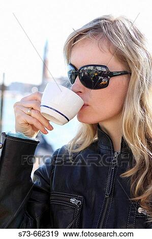 Stock Photo - 30 year old woman drinking coffee. Fotosearch