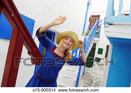 Picture - 30 year old woman in a Mykonos street, Cyclades Islands, Greece, Europe. Fotosearch