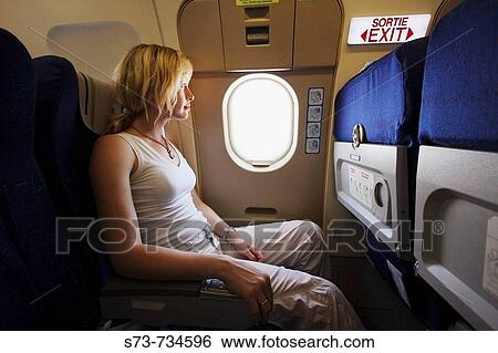 30 year old woman in a plane by emergency exit View Large Photo Image Stock Photograph - 30 year old woman in a plane by emergency exit. Fotosearch