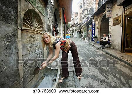 30 year old woman refreshing herself at fountain by the Gran Bazaar, Istanbul, Turkey View Large Photo Image Stock Image - 30 year old woman refreshing herself at fountain by the Gran Bazaar, Istanbul, Turkey. Fotosearch