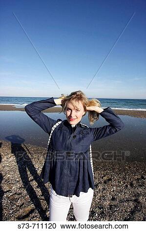 Stock Image - 30 years old woman at the beach. Fotosearch
