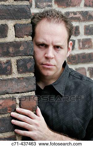 30's caucasian man peering around corner View Large Photo Image Stock Image - 30's caucasian man peering around corner. Fotosearch