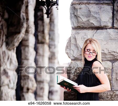 31 year old blond woman wearing reading glasses holding a law book in an out door urban setting View Large Photo Image Stock Photo - 31 year old blond woman wearing reading glasses holding a law book in an out door urban setting. Fotosearch