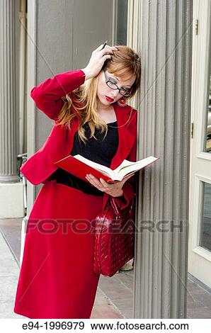 31 year old red headed woman in a business suit in an urban environment holding a law book. View Large Photo Image Stock Photo - 31 year old red headed woman in a business suit in an urban environment holding a law book.. Fotosearch